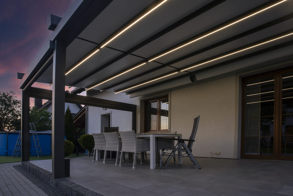 large, covered patio illuminated by LED light with aluminum patio doors